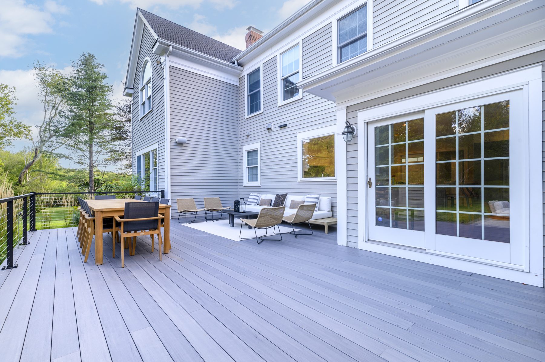 Composite deck with dining table and outdoor lounge