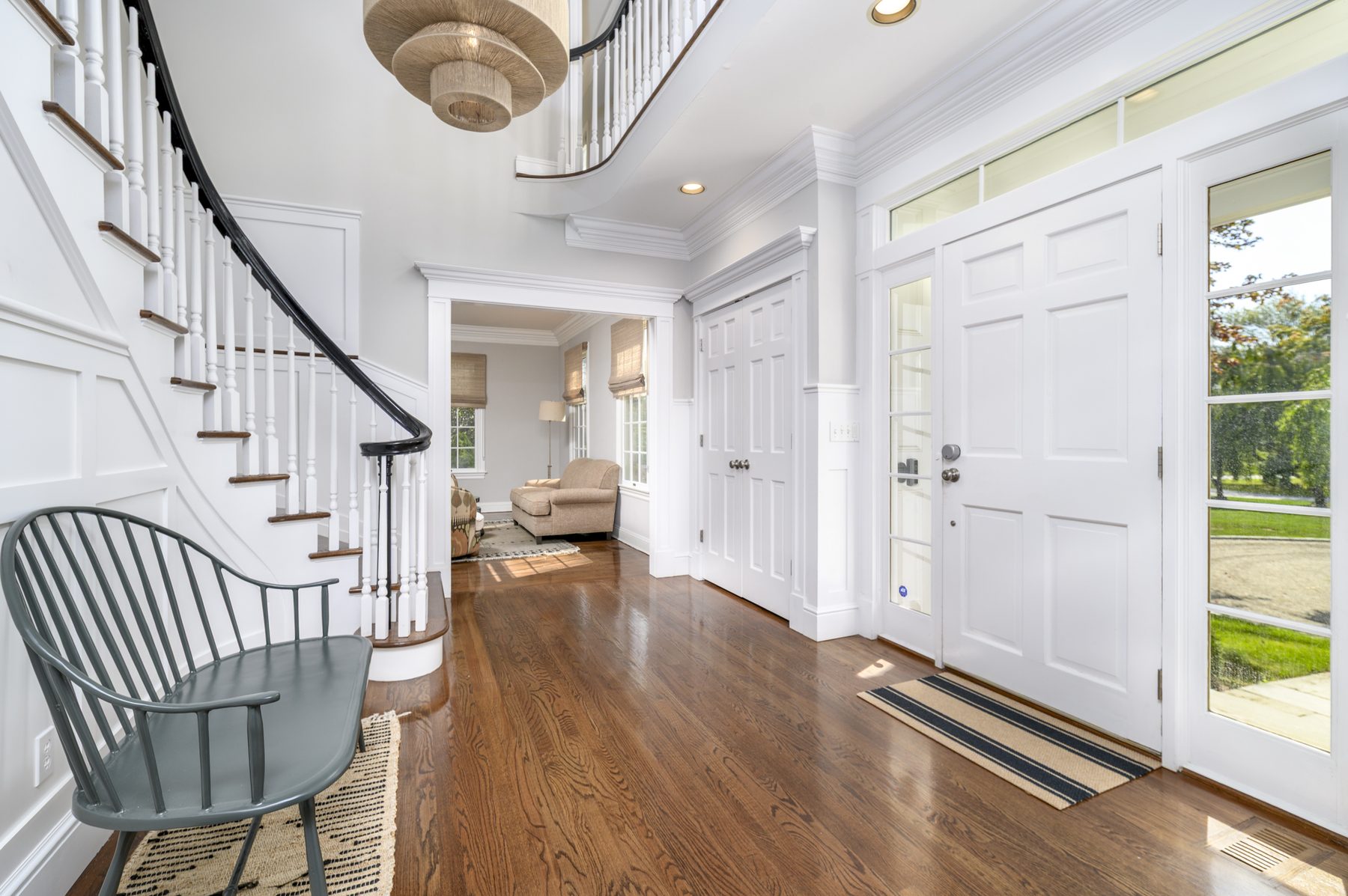 Bright entry foyer with curved staircase