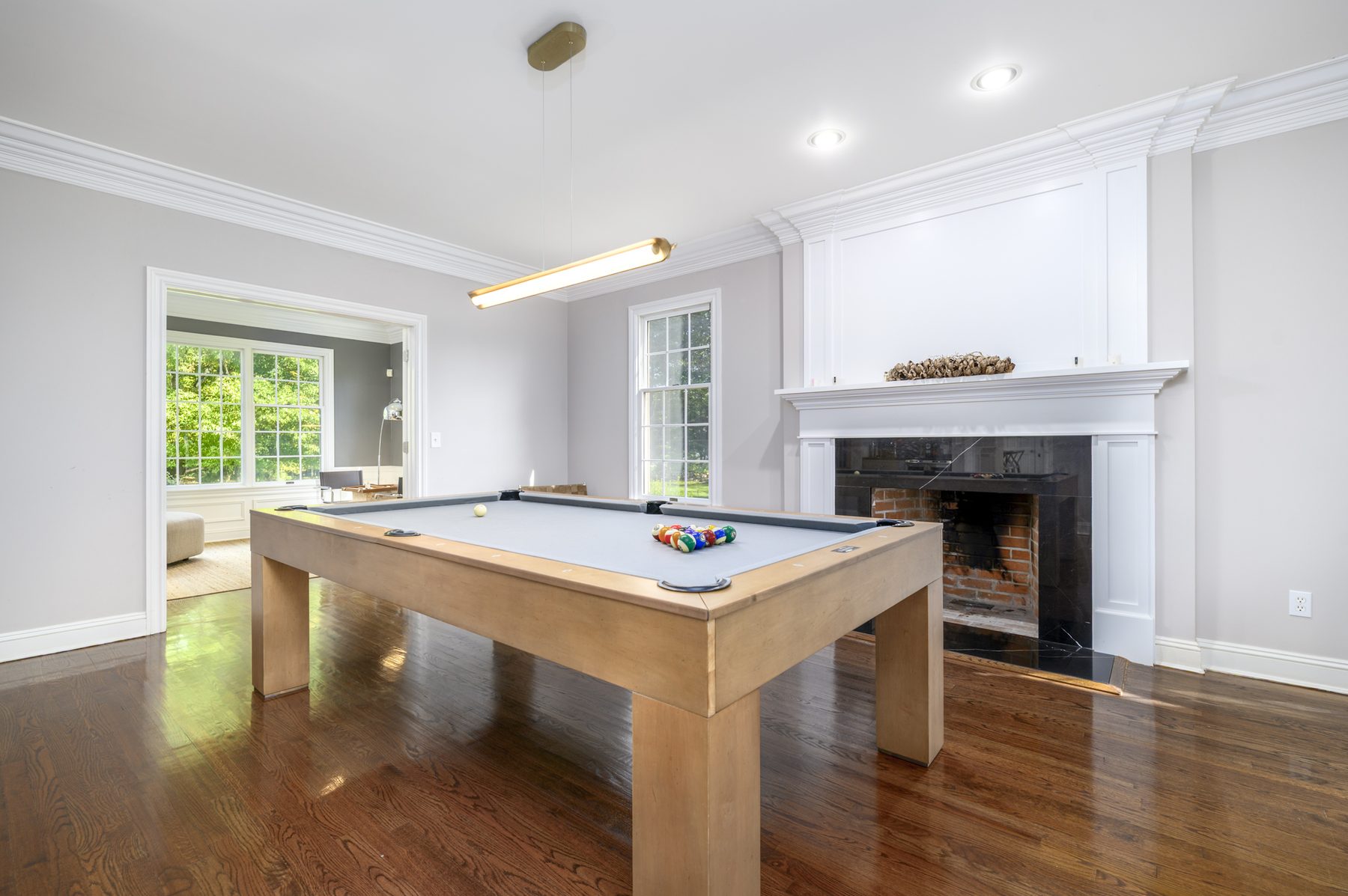Pool table room with full-size pool table, wet bar and fireplace