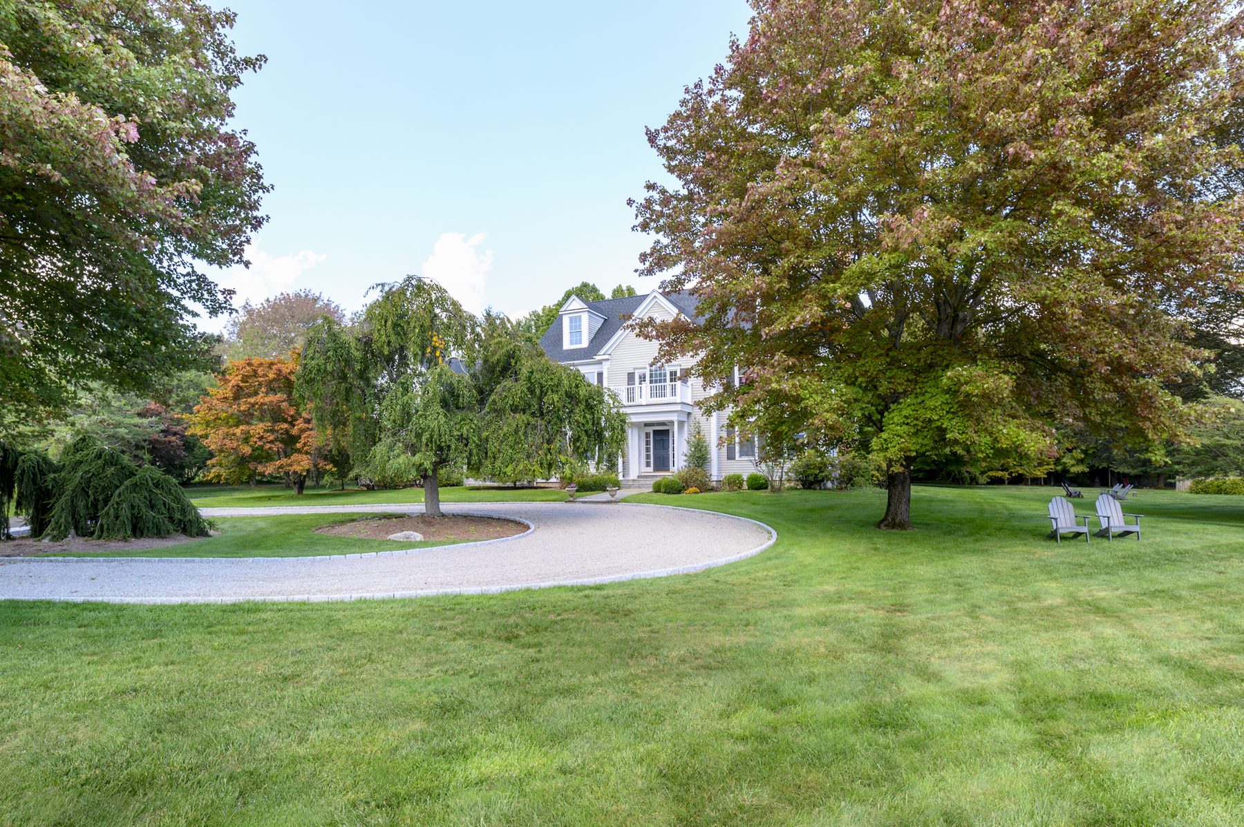 Curved gravel driveway approaching the house through landscaped grounds